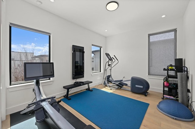 exercise area with recessed lighting, wood finished floors, and baseboards