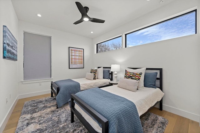 bedroom with recessed lighting, baseboards, light wood-style flooring, and ceiling fan