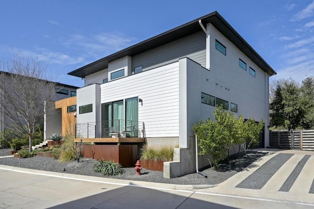 view of side of property featuring fence