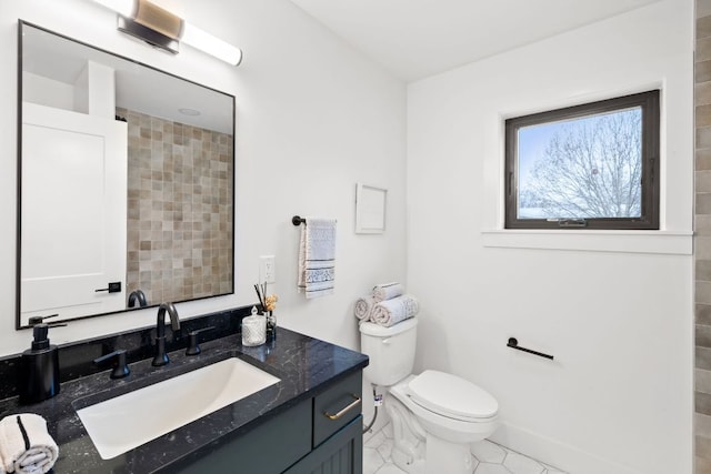 bathroom featuring baseboards, toilet, vanity, and tile patterned flooring