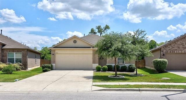 view of front of property featuring an attached garage, concrete driveway, a front yard, and fence