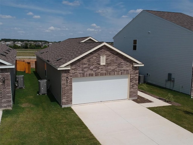 view of front facade with a front lawn, cooling unit, brick siding, and an attached garage