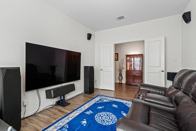living room with wood finished floors and visible vents