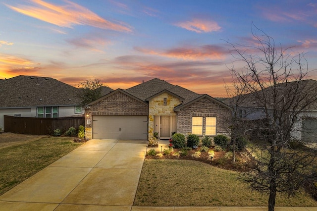 701 Mallow Rd, Leander, TX 78641 - view of front of property featuring concrete driveway, an attached garage, stone siding, and brick siding