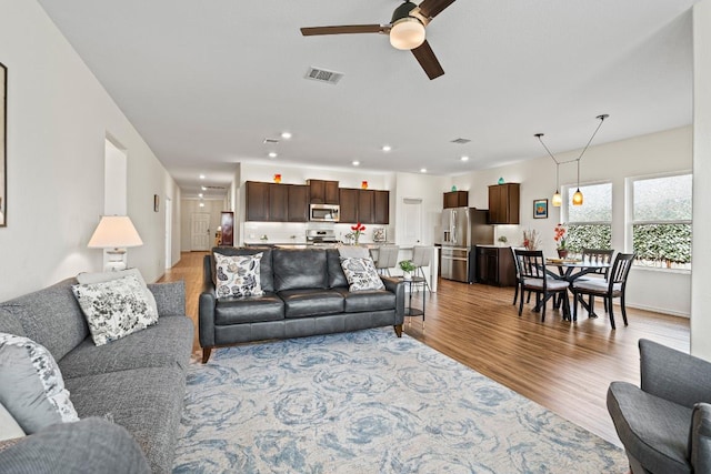 701 Mallow Rd, Leander, TX 78641 - living room with light wood-type flooring, a ceiling fan, and recessed lighting