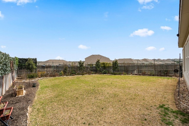 view of yard with a fenced backyard