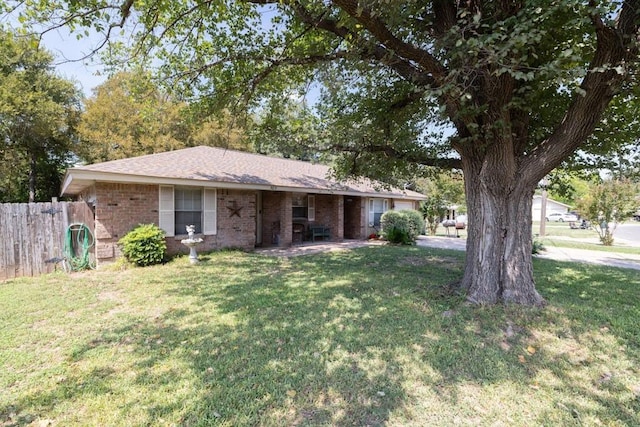 single story home with brick siding, a front yard, and fence