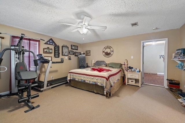 bedroom featuring visible vents, carpet flooring, a textured ceiling, and a ceiling fan