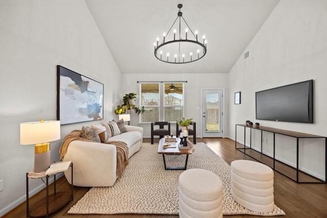 living room with visible vents, baseboards, high vaulted ceiling, and wood finished floors