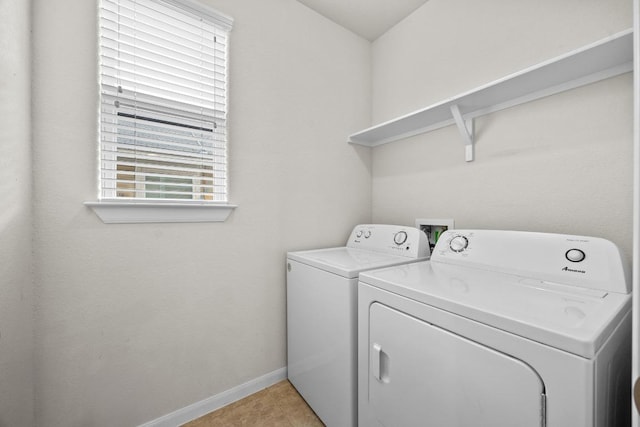 laundry room featuring washer and dryer, baseboards, and laundry area