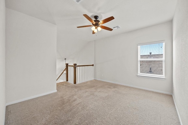 unfurnished room with carpet flooring, baseboards, visible vents, and ceiling fan