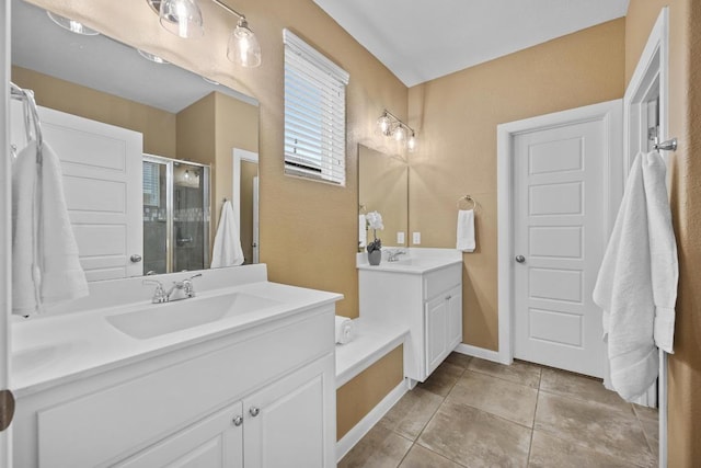 bathroom with a sink, two vanities, a shower stall, and tile patterned floors