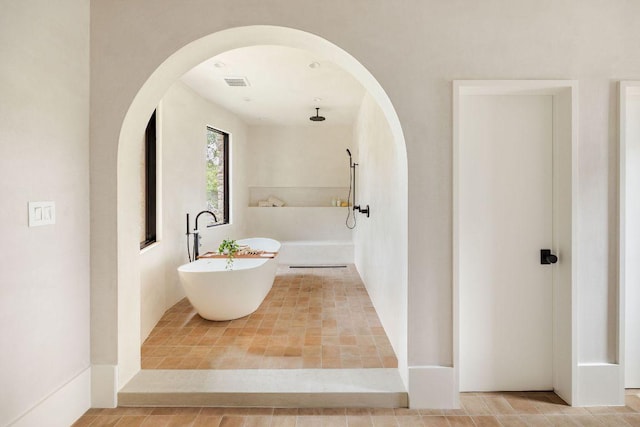 full bath featuring visible vents, a freestanding bath, and walk in shower