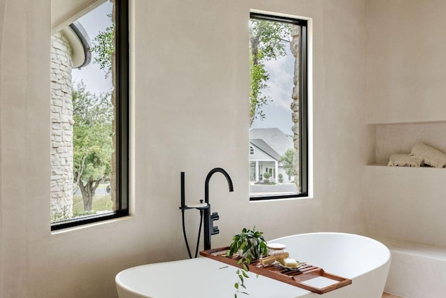 bathroom with a freestanding tub