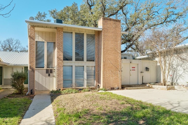 121 Scott St, San Marcos, TX 78666 - view of front of property with brick siding, a chimney, and a gate