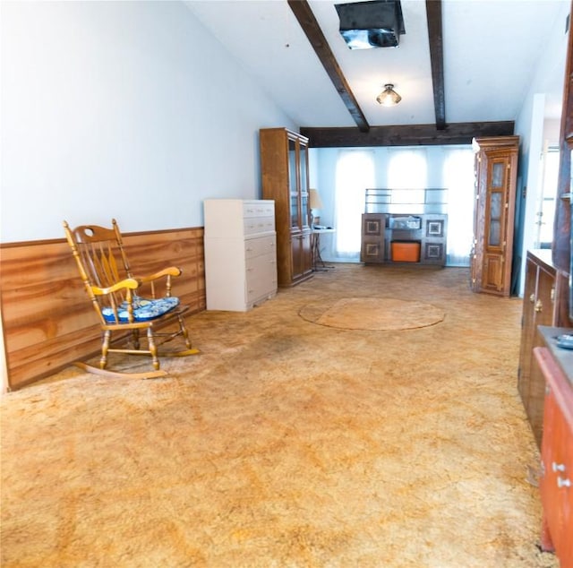 living area featuring a wealth of natural light and vaulted ceiling with beams