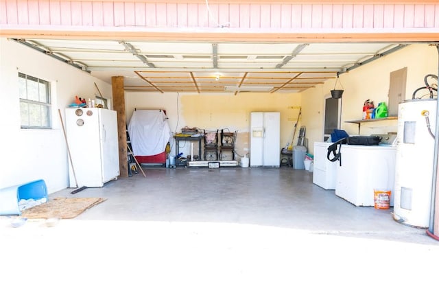 garage featuring electric panel, water heater, freestanding refrigerator, white fridge with ice dispenser, and washing machine and dryer