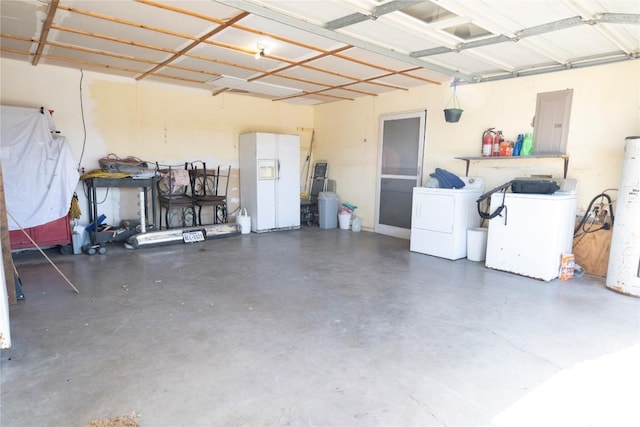 garage with independent washer and dryer, electric panel, fridge, gas water heater, and white fridge with ice dispenser