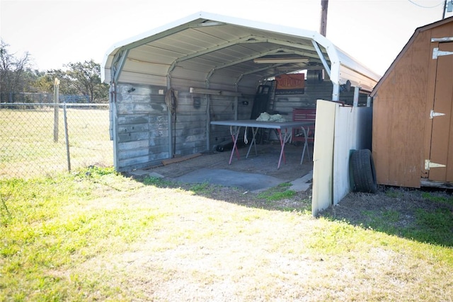 view of vehicle parking with a carport and fence