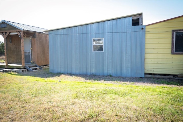 view of property exterior featuring an outdoor structure and a yard