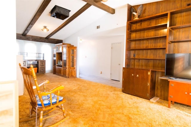 unfurnished living room with carpet flooring, vaulted ceiling with beams, baseboards, and visible vents