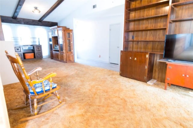 unfurnished living room with visible vents, lofted ceiling with beams, and carpet