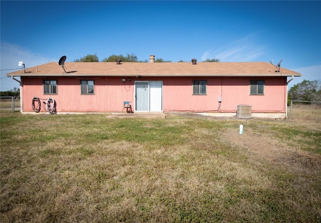 back of house with a yard, cooling unit, and fence