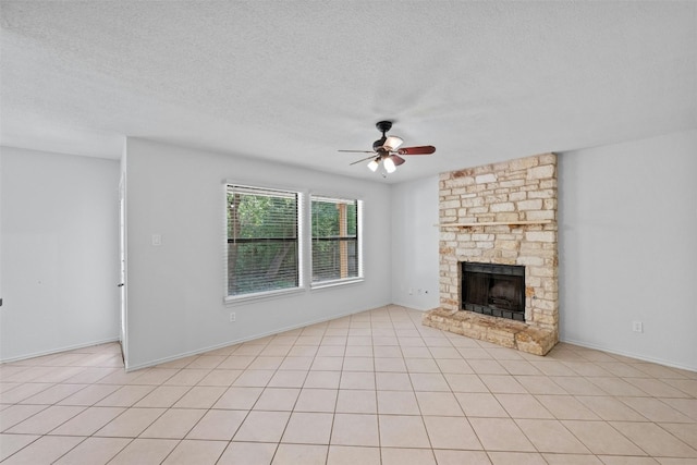 unfurnished living room featuring a ceiling fan, a fireplace, and a textured ceiling