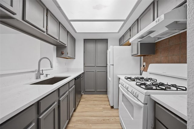 kitchen featuring gray cabinets, under cabinet range hood, a sink, gas range gas stove, and dishwasher