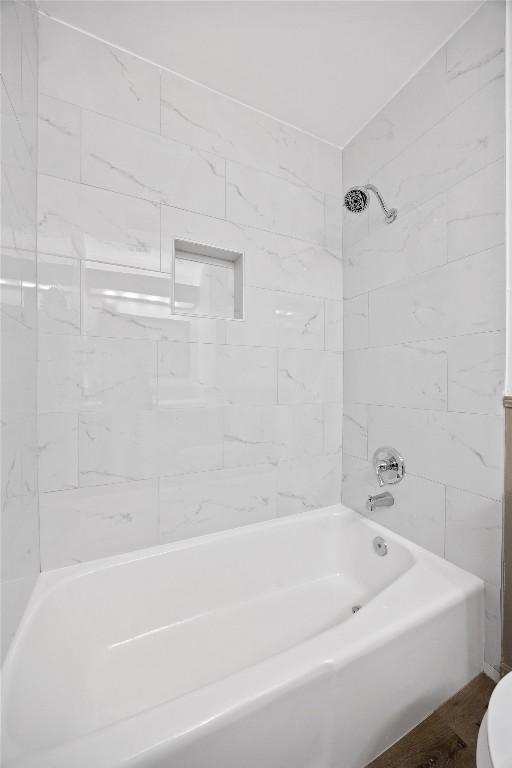 bathroom featuring toilet and shower / tub combination