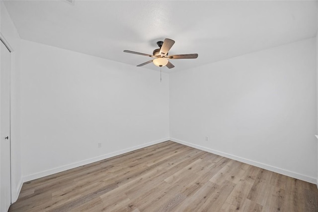 unfurnished room with a ceiling fan, baseboards, and light wood finished floors