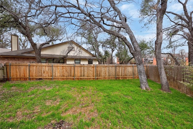 view of yard with a fenced backyard