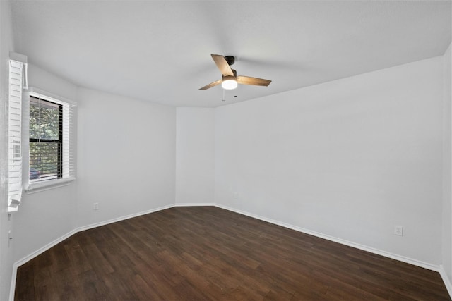 unfurnished room with a ceiling fan, wood finished floors, and baseboards