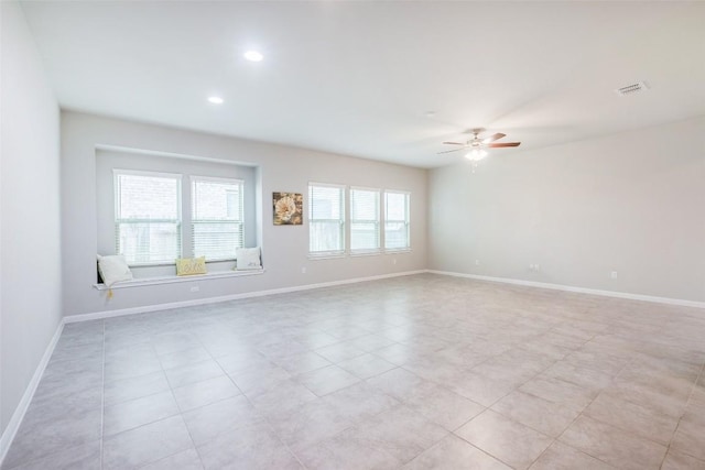 empty room with recessed lighting, visible vents, ceiling fan, and baseboards