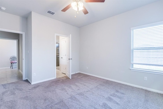 unfurnished bedroom with visible vents, ceiling fan, baseboards, and carpet