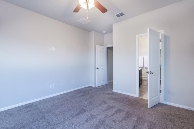 unfurnished bedroom featuring carpet, visible vents, ensuite bathroom, and baseboards