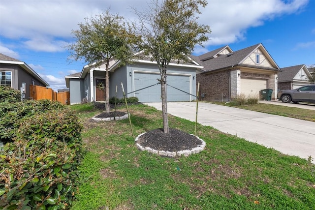 view of front facade featuring fence, driveway, an attached garage, stucco siding, and a front lawn