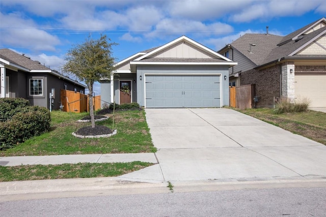 view of front of house featuring board and batten siding, driveway, a garage, and fence