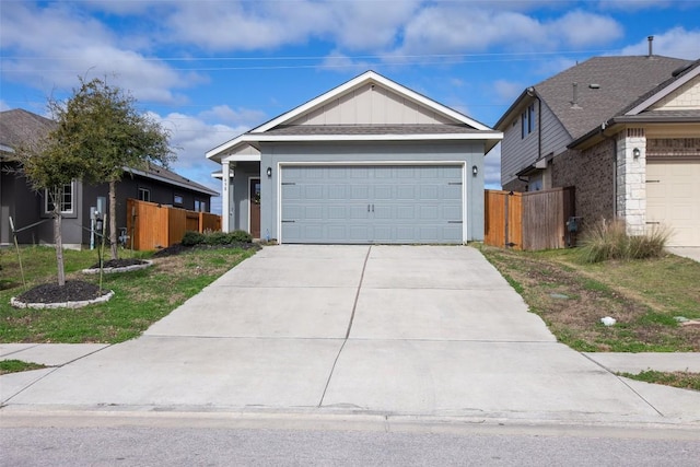 ranch-style home with a garage, board and batten siding, driveway, and fence