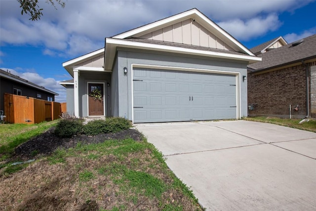 ranch-style house featuring a garage, board and batten siding, driveway, and fence