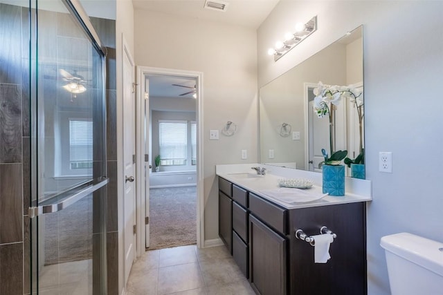 bathroom with tile patterned floors, visible vents, toilet, a shower with door, and vanity