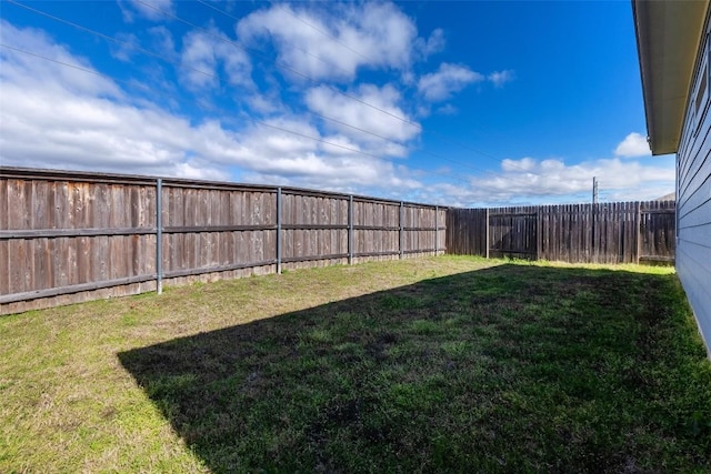 view of yard with a fenced backyard