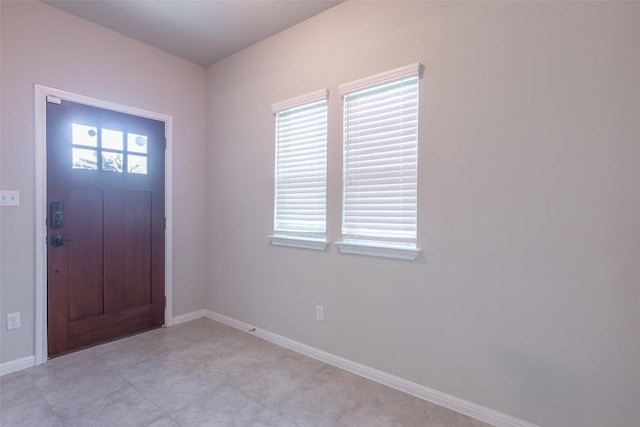 foyer entrance featuring baseboards