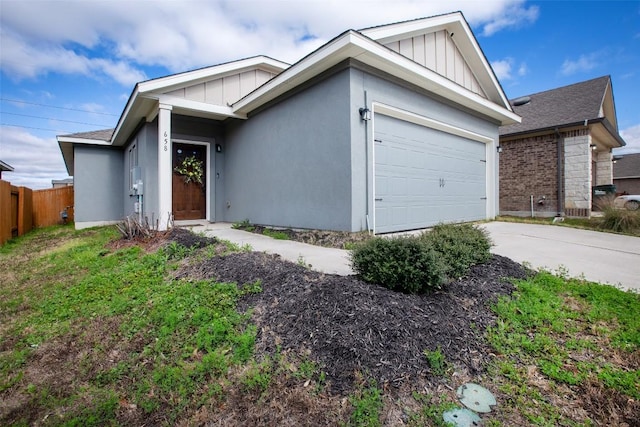 single story home featuring board and batten siding, an attached garage, driveway, and fence