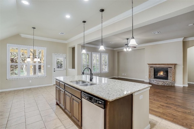 kitchen with visible vents, a fireplace, ornamental molding, a sink, and stainless steel dishwasher