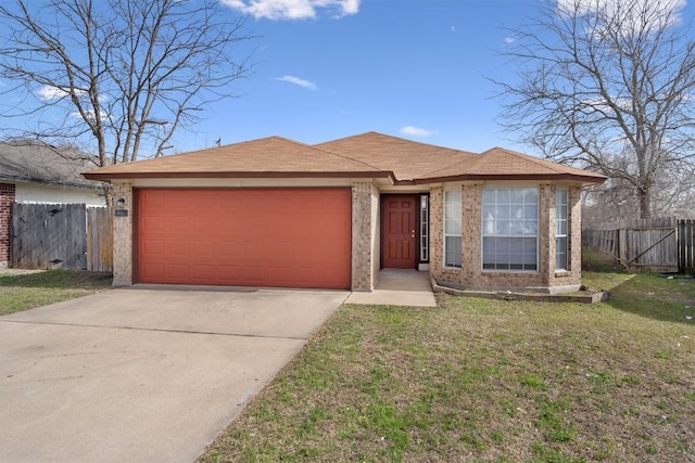 view of front of home with a front lawn, an attached garage, fence, and concrete driveway