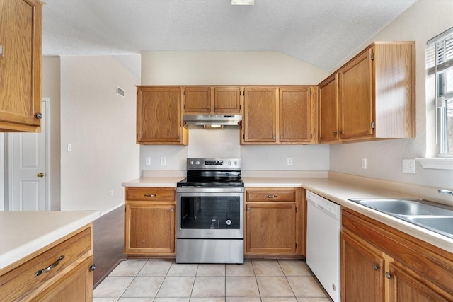 kitchen featuring light tile patterned floors, white dishwasher, a sink, stainless steel range with electric cooktop, and under cabinet range hood