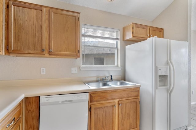 kitchen with white appliances, light countertops, and a sink