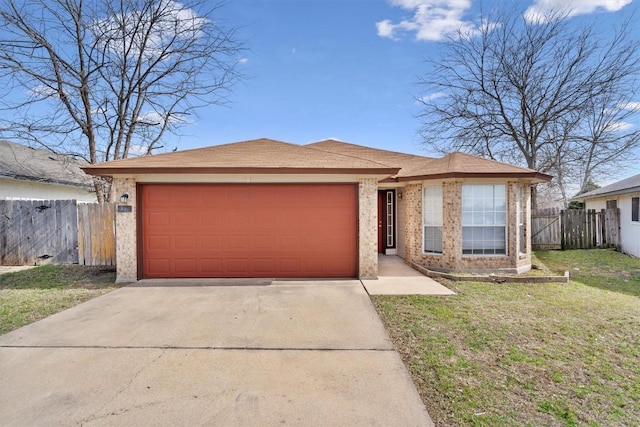 view of front facade with brick siding, fence, concrete driveway, a front yard, and an attached garage