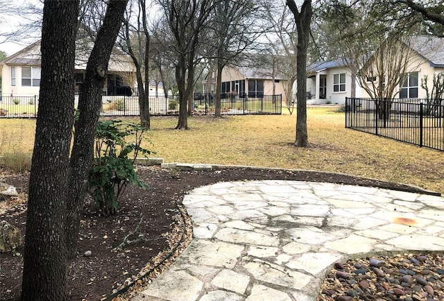 view of yard featuring a patio area, a residential view, and fence